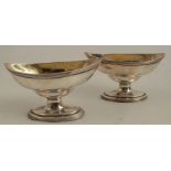 A pair of Georgian silver oval pedestal salts, with ribbed bands, London 1724, maker Peter, Anne and