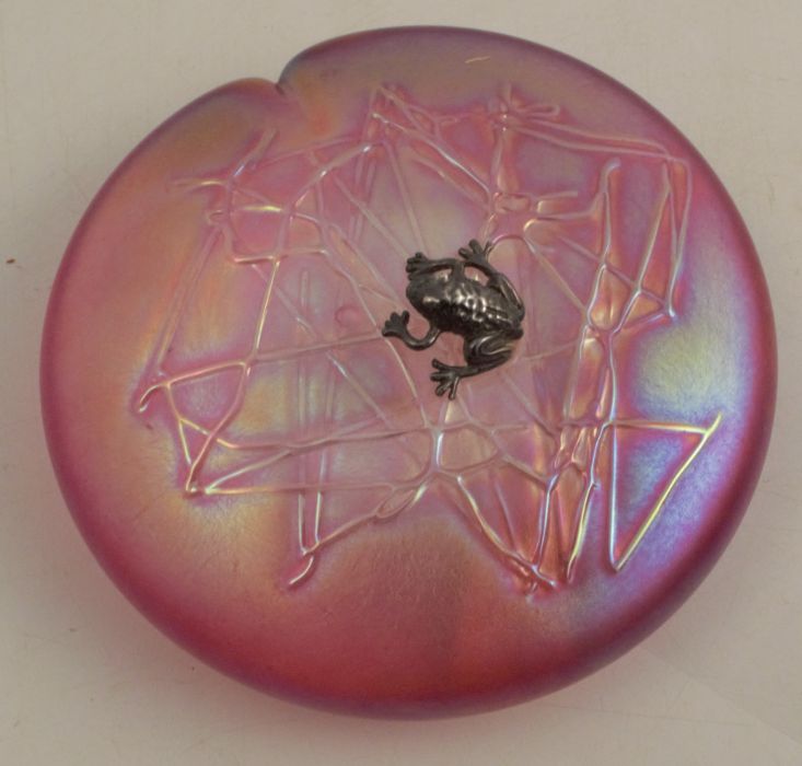 A Glasform pink iridescent glass paperweight, mounted with a silver frog, etched J Ditchfield to