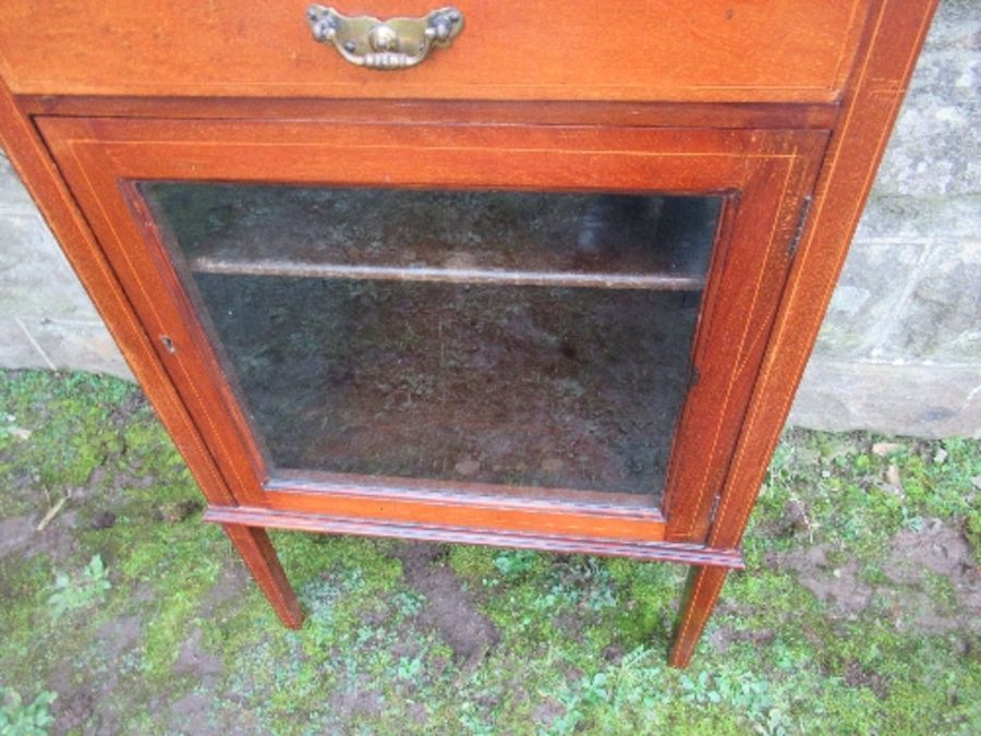 An Edwardian music cabinet, with three drop down drawers, over a glazed door, raised on tapering - Image 6 of 7