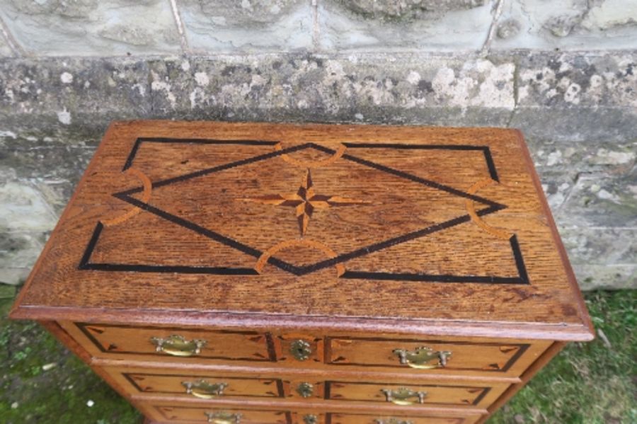 An 18th century design small oak chest on stand, with three drawers, having inlaid and cross - Image 2 of 5