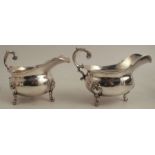 A pair of Elkington and Co silver plated sauce boats, with double C scroll handle, raised on