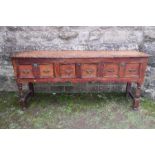 An antique style oak dresser base, fitted with three drawers, over a shaped apron, width 69in x