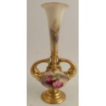 A Royal Worcester vase, decorated with red roses, with gilt fish handles, on a gilt pedestal foot,