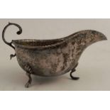A silver sauce boat, with bead edge and raised on three scroll feet, Birmingham 1902, weight 3oz
