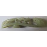 A Chinese jade belt buckle, in the form of a dragon looking at a walking lizard, length 6.25ins -