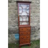 A 19th century narrow mahogany bookcase chest, the upper section having a single astragal door,