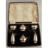 A cased silver six piece condiment set, with band of decoration, Birmingham 1934