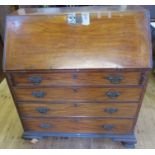 A Georgian mahogany bureau, the fall flap opening to reveal a shaped interior with drawers and