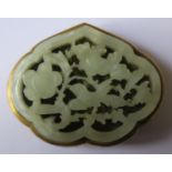 A Chinese jade leaf shaped mounted buckle, pierced and decorated with birds and foliage, having a