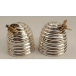 A pair of modern hallmarked silver cruet pots, formed as bee hives with silver gilt bees, weight