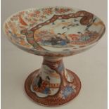 An antique Kutani porcelain tazza, decorated all over with cockerels, birds and flowers, two
