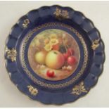 A Royal Worcester dish, of shaped circular form, the centre painted with fruit to a mossy background