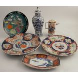 A group of Oriental china, to include wall plates, oblong dish, a covered vase decorated in blue and
