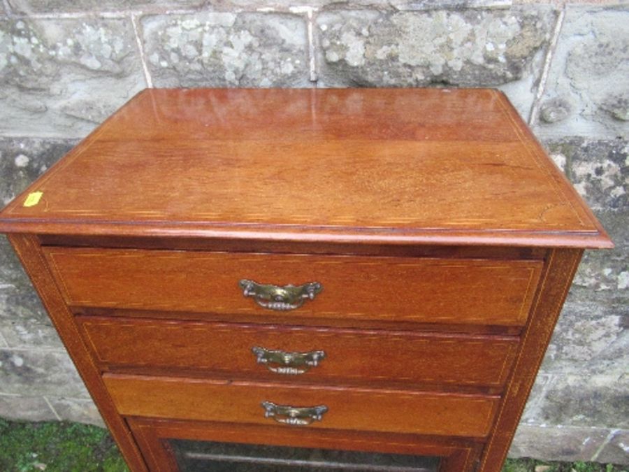 An Edwardian music cabinet, with three drop down drawers, over a glazed door, raised on tapering - Image 4 of 7