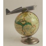 An Art Deco style globe, surmounted by a stylised 1930's type chrome plane, max height 7.5ins