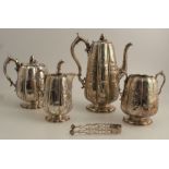A Victorian silver four piece tea set, the lobbed body embossed with flowers and leaves, with bud