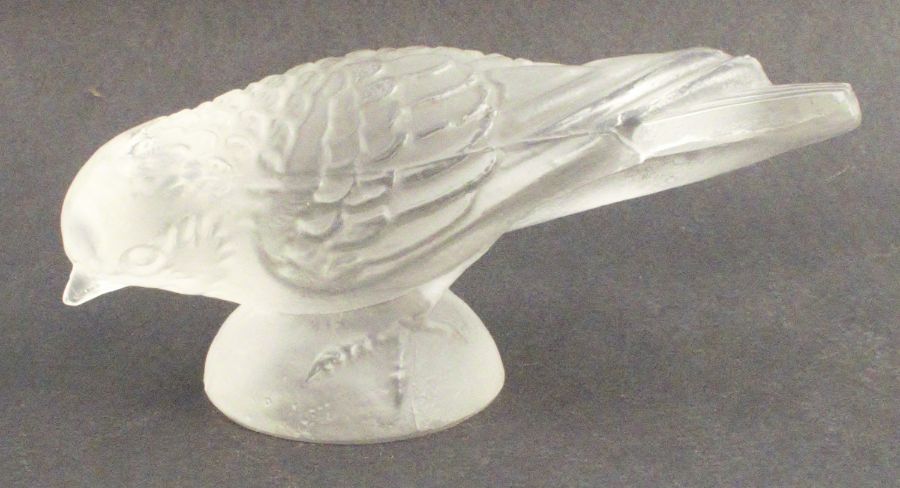 A Lalique bird, surmounted on a domed pedestal, width 4.75ins - The beak is rough to touch but