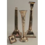 A pair of hallmarked silver candlesticks, one af, weight 22oz, together with a loaded hallmarked