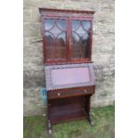 An Edwardian Art Nouveau style bureau bookcase, the upper section having two glazed doors below a