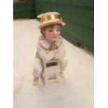 A 19th century Royal Worcester Kate Greenaway style figure, of a young boy seated the wrong way on a