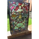 A 19th century stained glass panel, of rectangular form, depicting a saint, on an oak base, size