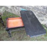 An ebonised fold over card table, of rectangular form, raised on four turned legs united by