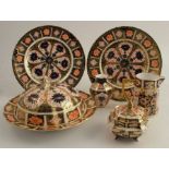 Two Royal Crown Derby plates, decorated with the Imari pattern, a similar muffin dish, a covered