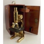 A 19th century cased precision microscope no.775, by Flatters and Garnett, Manchester, in mahogany