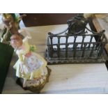 A metal letter rack, with classical details, together with a porcelain lamp base of a girl by a