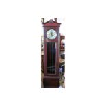 An Edwardian mahogany long case clock, with circular dial and glazed door with Westminster chimes,