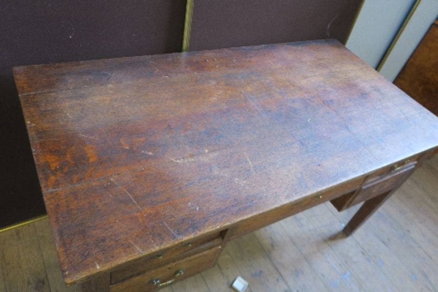 An early 20th century oak desk of rectangular form, fitted with one central drawer above a kneehole, - Image 3 of 4