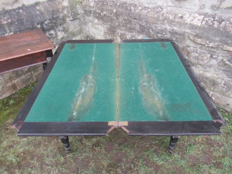 An ebonised fold over card table, of rectangular form, raised on four turned legs united by - Image 2 of 6