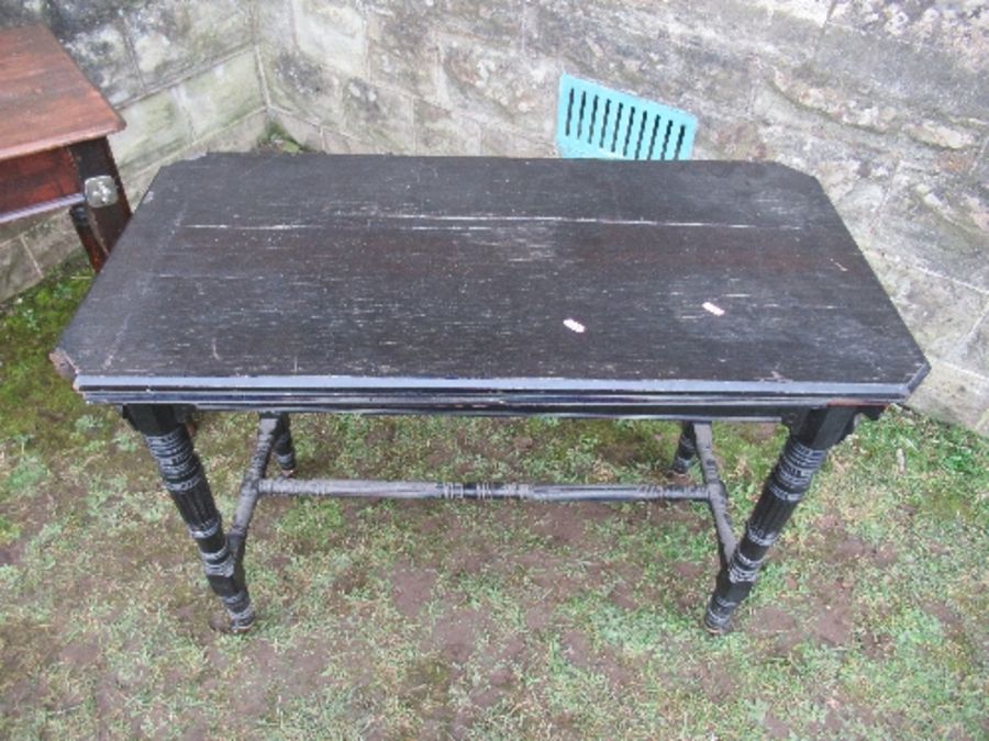 An ebonised fold over card table, of rectangular form, raised on four turned legs united by - Image 4 of 6