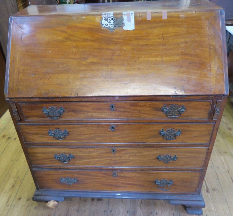 A Georgian mahogany bureau, the fall flap opening to reveal a shaped interior with drawers and