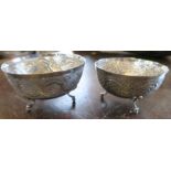 Two Continental silver bowls, with a band of decoration, raised on three scroll feet, marked 830,