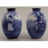 A pair of Royal Doulton blue vases, decorated with children in an all around landscape, height 4ins