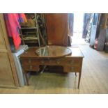 A Warings mahogany dressing table, with shield shaped mirror, the base fitted with drawers around