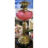 A Duplex 1 1/16 wick brass oil lamp, with cranberry glass reserve