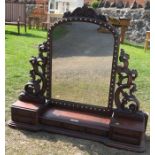 A 19th century dressing table mirror, of carved end supports, the base fitted with drawers, height