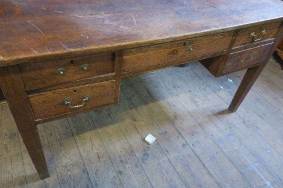 An early 20th century oak desk of rectangular form, fitted with one central drawer above a kneehole, - Image 2 of 4