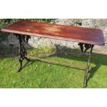 A rectangular wooden topped table, on cast iron base, 47.5ins x 18ins, height 28ins