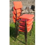A set of four children's plastic and metal stacking chairs