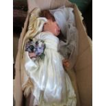 A doll, dressed in a wedding dress