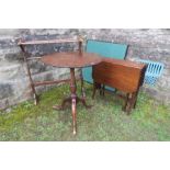 A mahogany circular topped tripod table, diameter 23ins, together with a Sutherland table, a towel