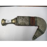 An Arabic Jambiya dagger, with horn handle inset with coins, and white metal scabbard