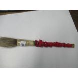 An Antique Chinese calligraphy brush with red stone handle