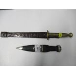 A Scottish dirk, together with a Stiletto knife, with brass handled and tooled leather sheath