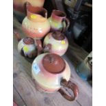 Three Torquay ware tea pots, and two jugs