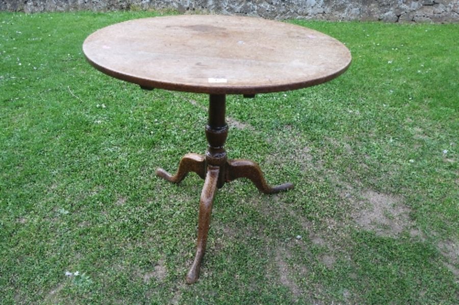 A 19th century oak tripod table, diameter 30.5ins x height 28ins