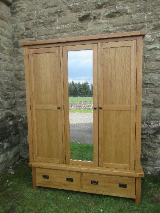 A modern oak mirror door wardrobe, width 59ins, depth 21ins, height 80ins, with British Design